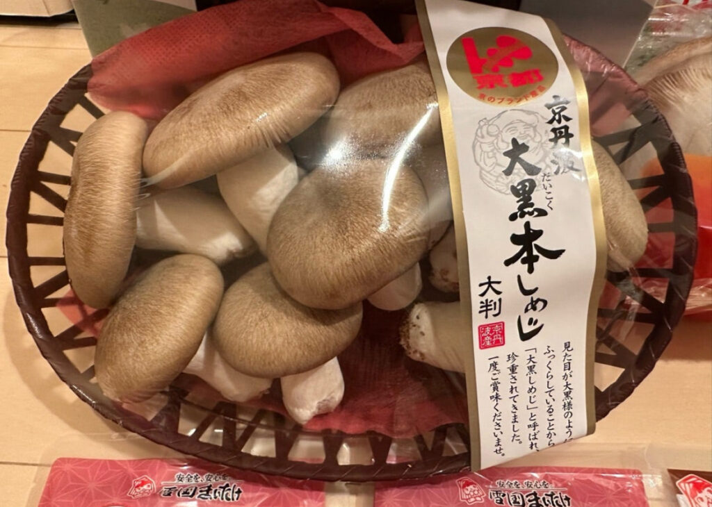 京丹波産『大黒本しめじ』が丁寧に詰められたかご盛りの状態。ラベルには『大判・京丹波産・国産』と記載されている。
