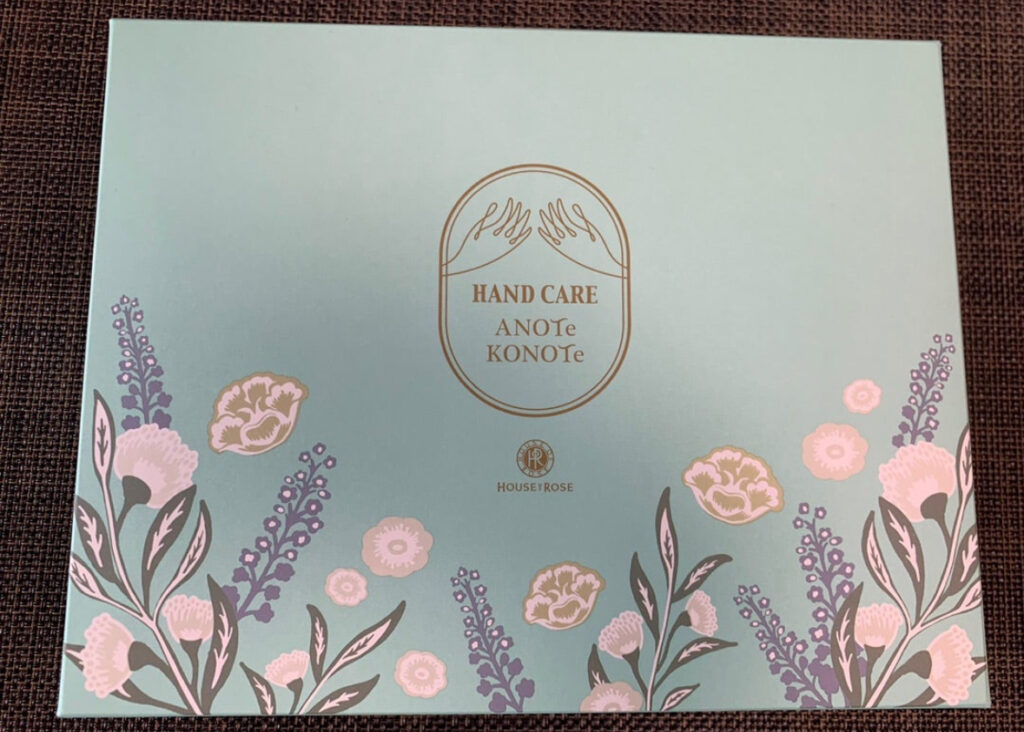 ハウスオブローゼ2022年株主優待の外箱。“HAND CARE ANOTe KONOTe”の文字と、優しい色合いの花のイラストが描かれたミントグリーンのパッケージデザイン。
