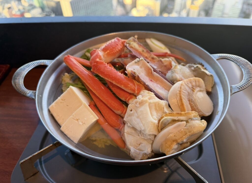 北の味紀行と地酒 北海道 カレッタ汐留店で提供された蟹鍋。ズワイ蟹やタラバ蟹、ホタテ、豆腐や野菜がたっぷり入った贅沢鍋。