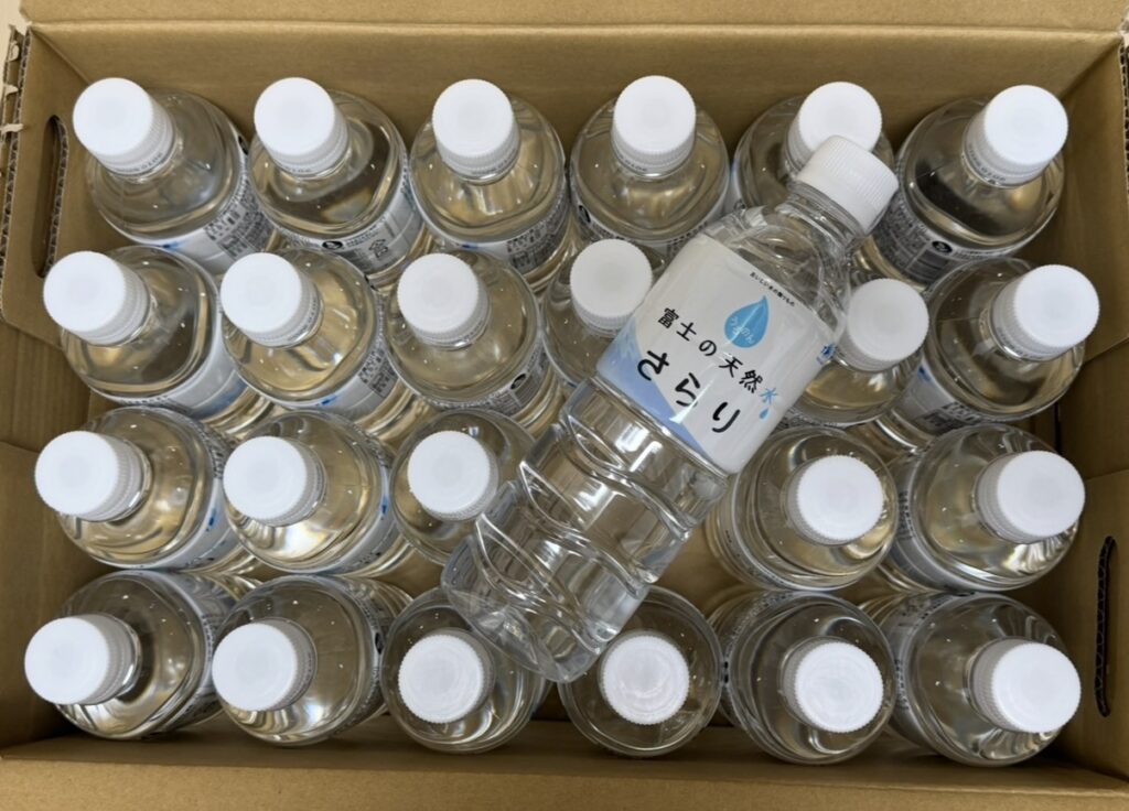 TOKAIホールディングス(3167)の株主優待で届いた「富士の天然水 さらり」500ml×24本。段ボールを開封するとペットボトルがぎっしり詰まっている様子