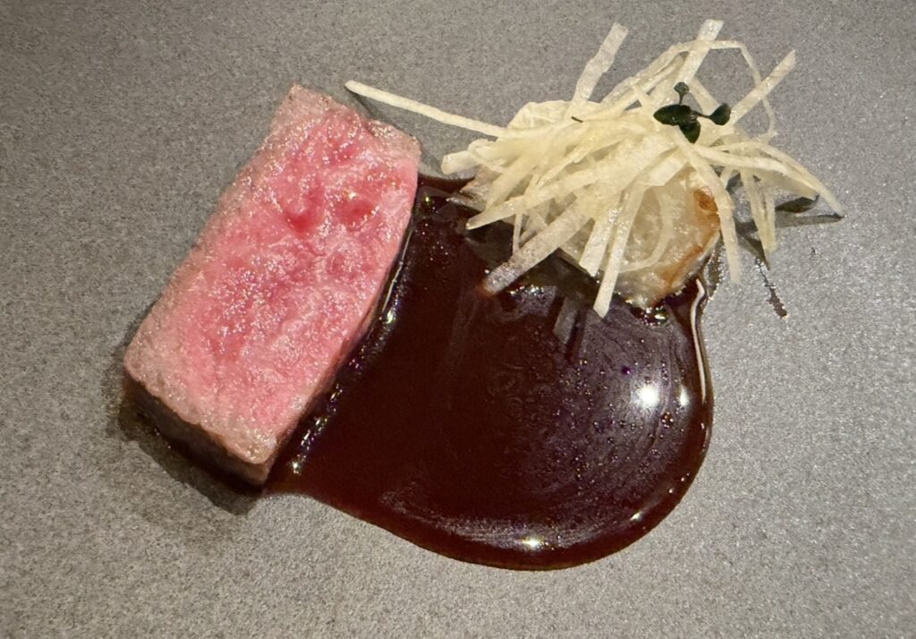 ひらまつ新店舗「HRMT STAGE」のコース料理のメイン、厳選和牛のロースト。蕪のヴァンルージュソースと千切り蕪を添えた美しい盛り付け。